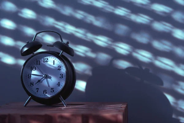 Soft nighttime scene with a glowing clock representing peaceful evening timing
